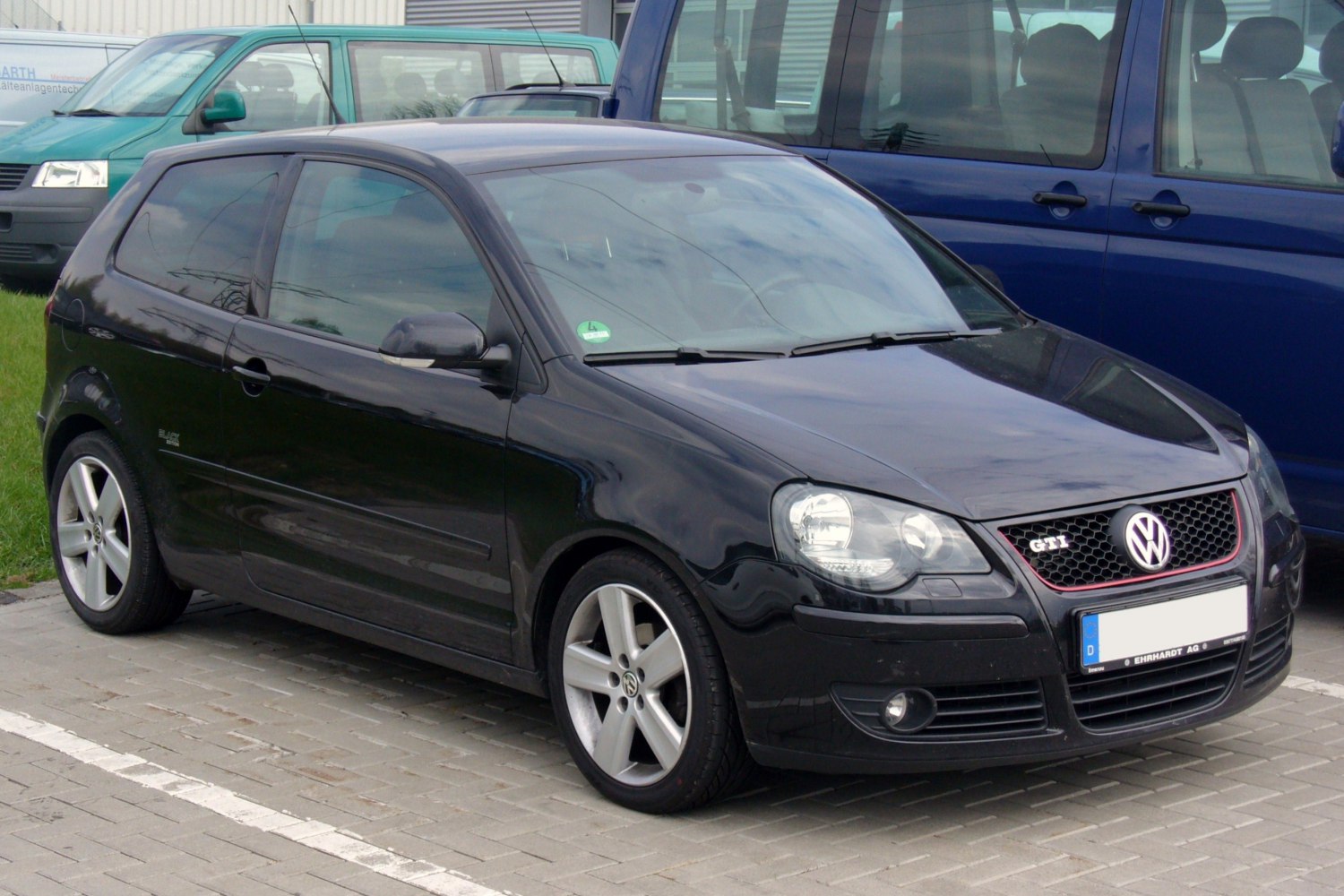 Black 3-door hatchback with alloy wheels and honeycomb grille