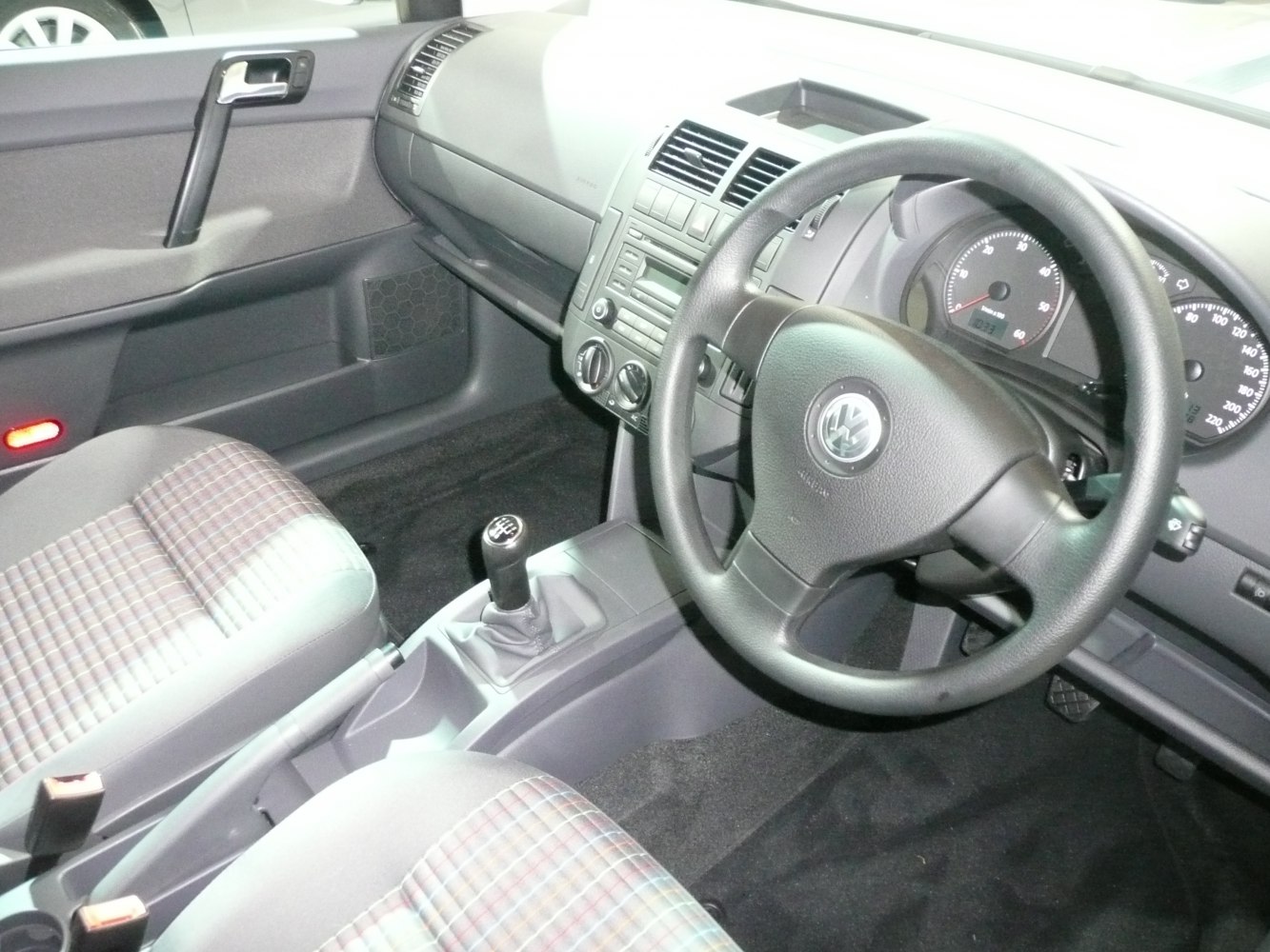 Manual gearshift, plaid fabric seats, classic dashboard