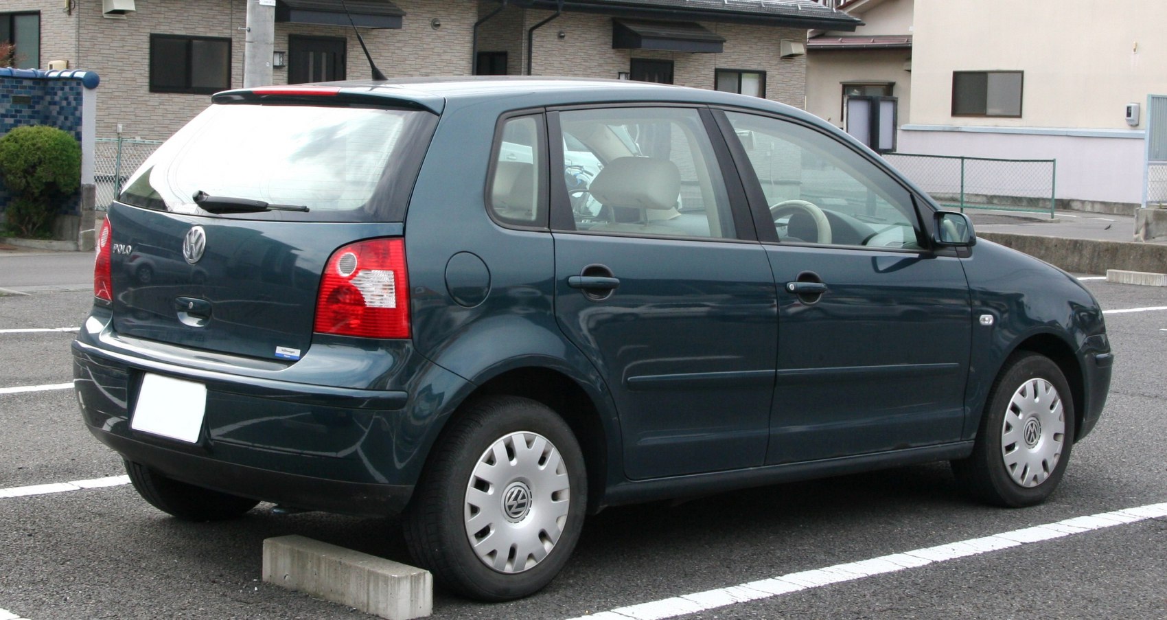 Hatchback rear view with taillights, rear window, and wheel details