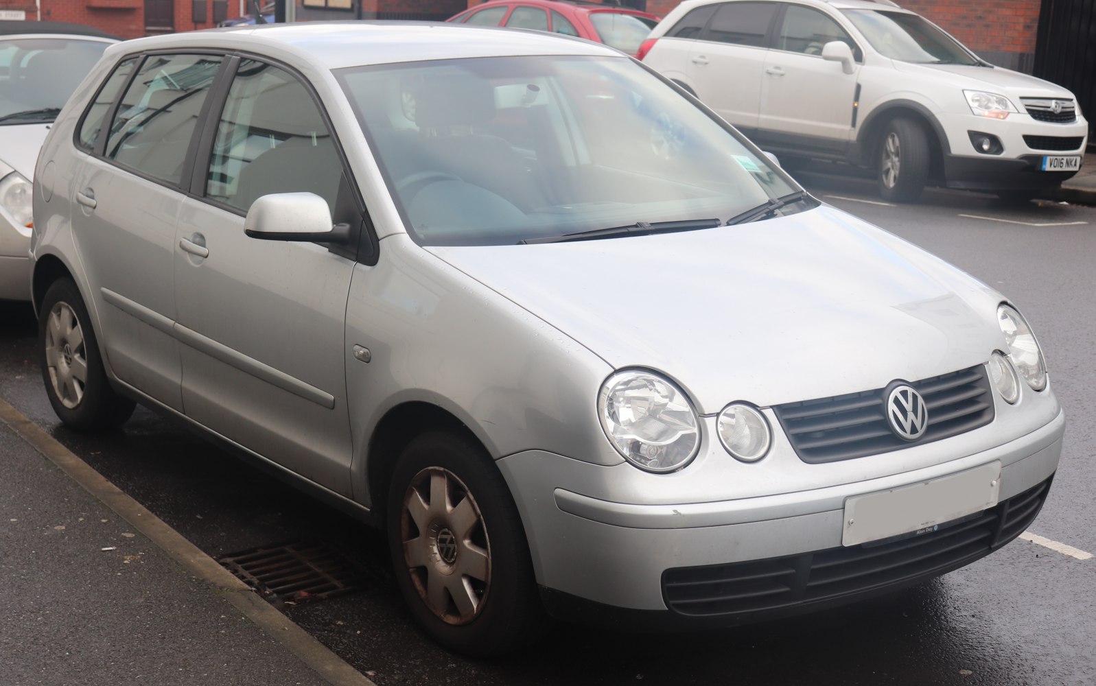 Silver 5-door hatchback with round headlamps and VW grille