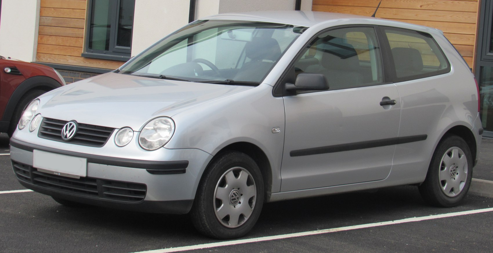 Silver hatchback car front-side view with round headlights and three-door design