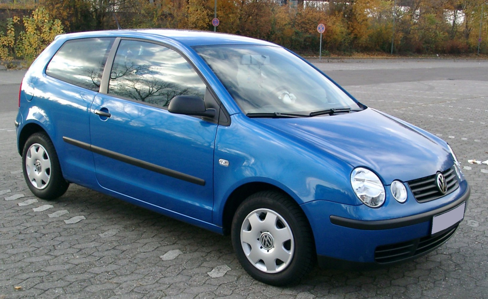 Blue 3-door hatchback with round headlights and compact body