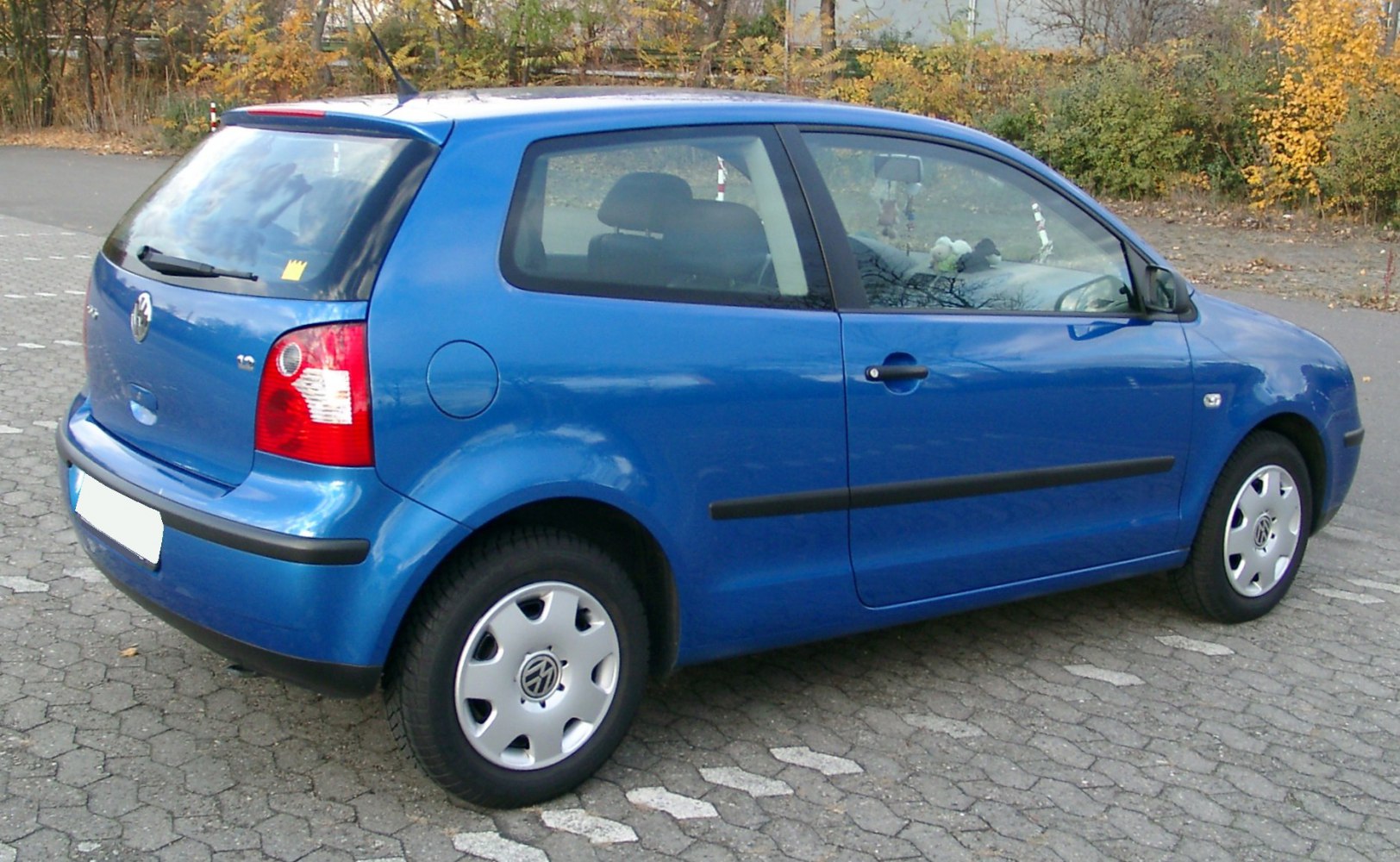 Blue compact 3-door hatchback with rear wiper and steel wheels