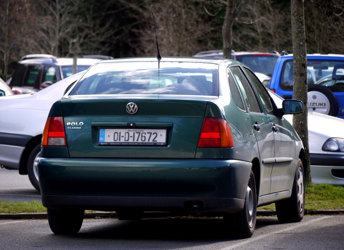 Rear view showing hatchback tail lights, bumper, and antenna