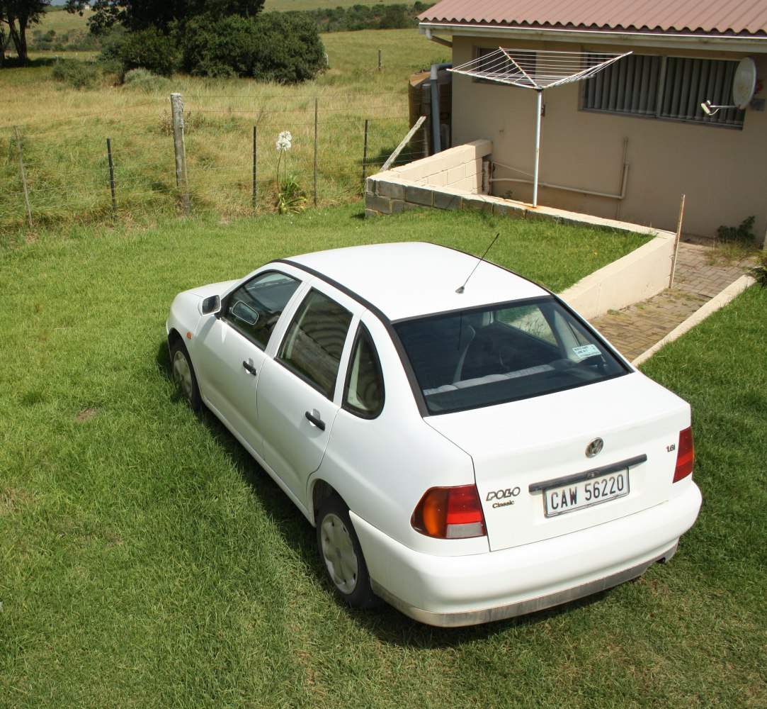 Rear view of a white 5-door hatchback with distinctive tail lights and rear window design.