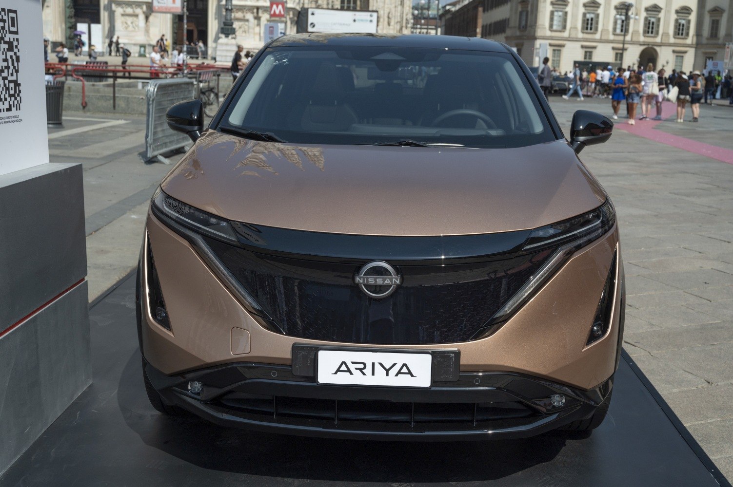 Futuristic LED headlights and bold front grille of an electric SUV