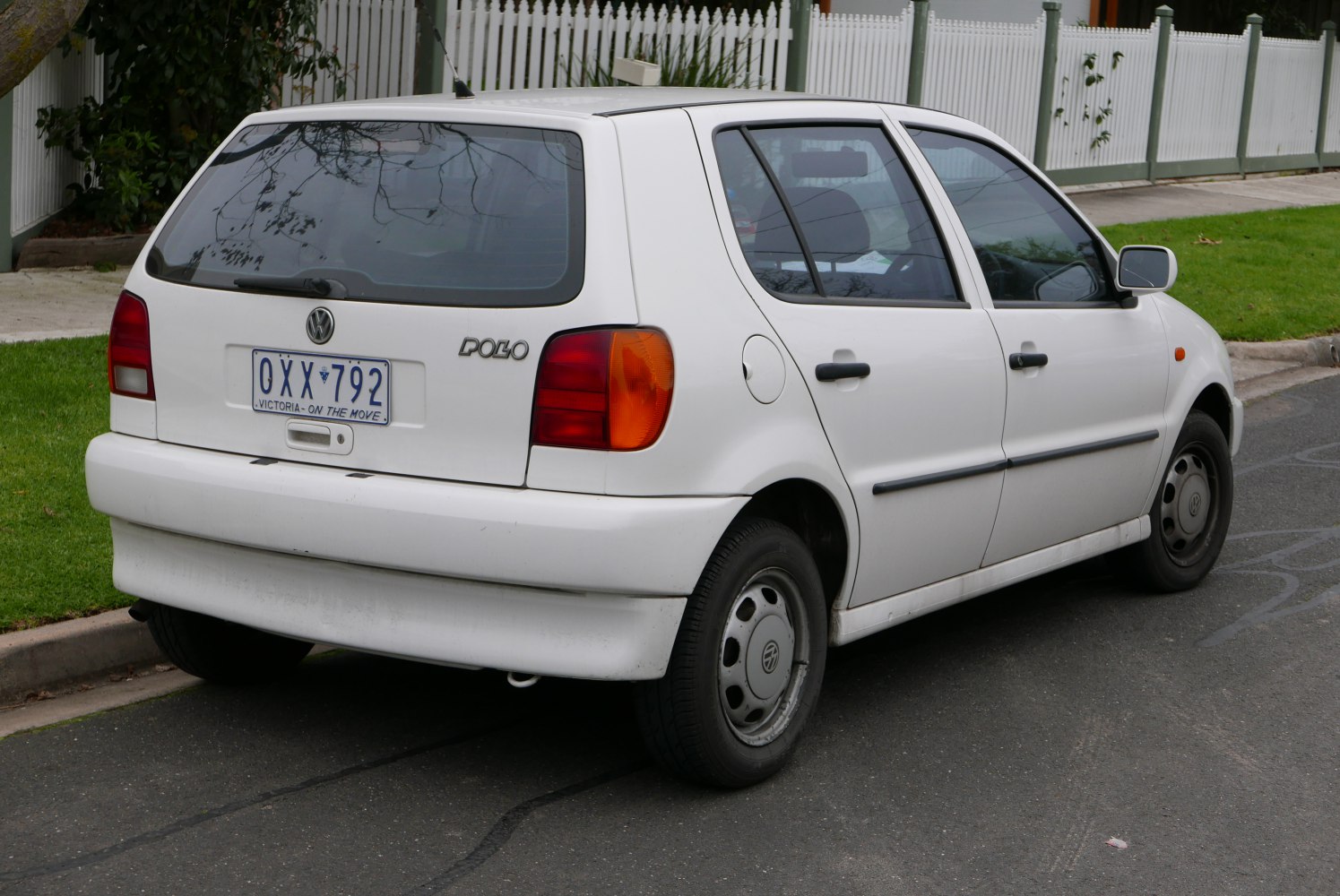 Rear and side view of white 1994 compact hatchback with distinctive taillights