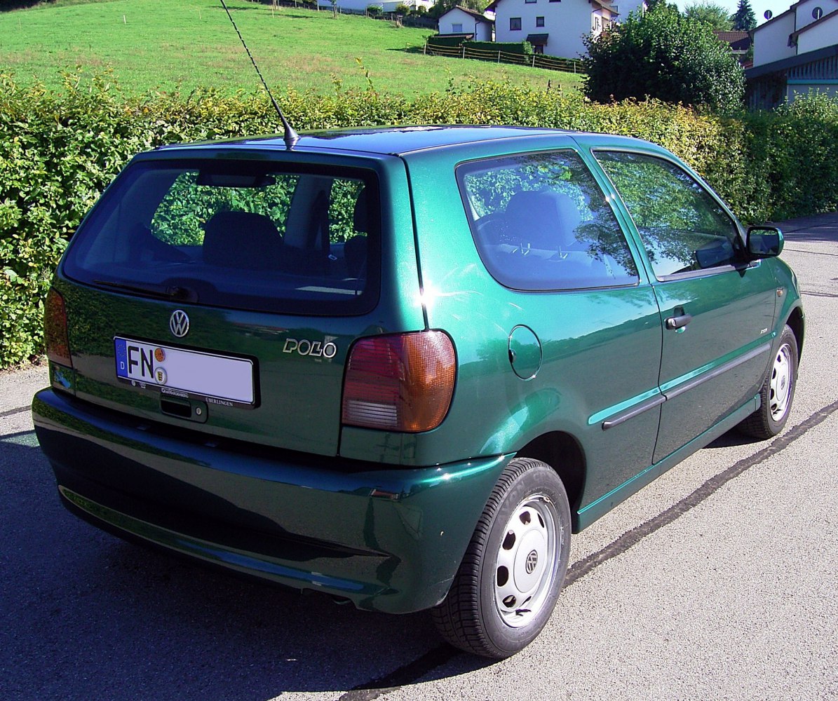 Rear three-quarter view of a compact hatchback with rounded taillights and 3-door design