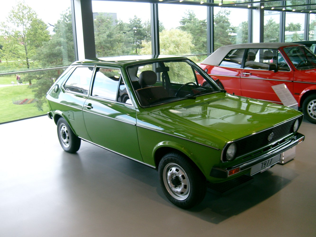 Classic compact hatchback with round headlights and steel wheels