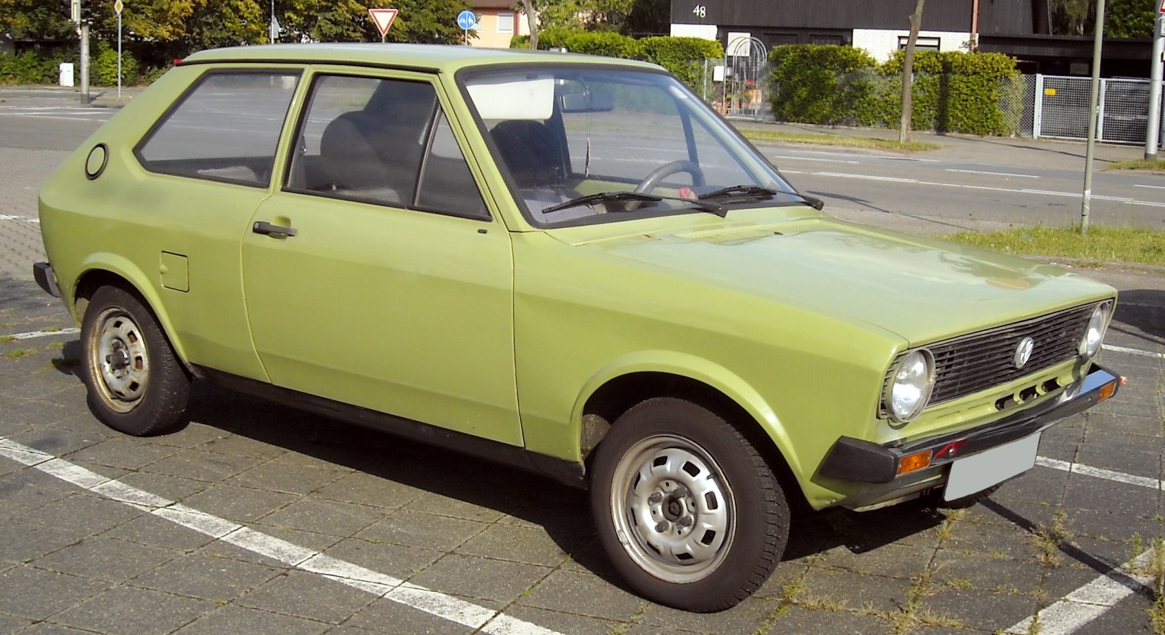 Vintage compact hatchback with round headlights and boxy design