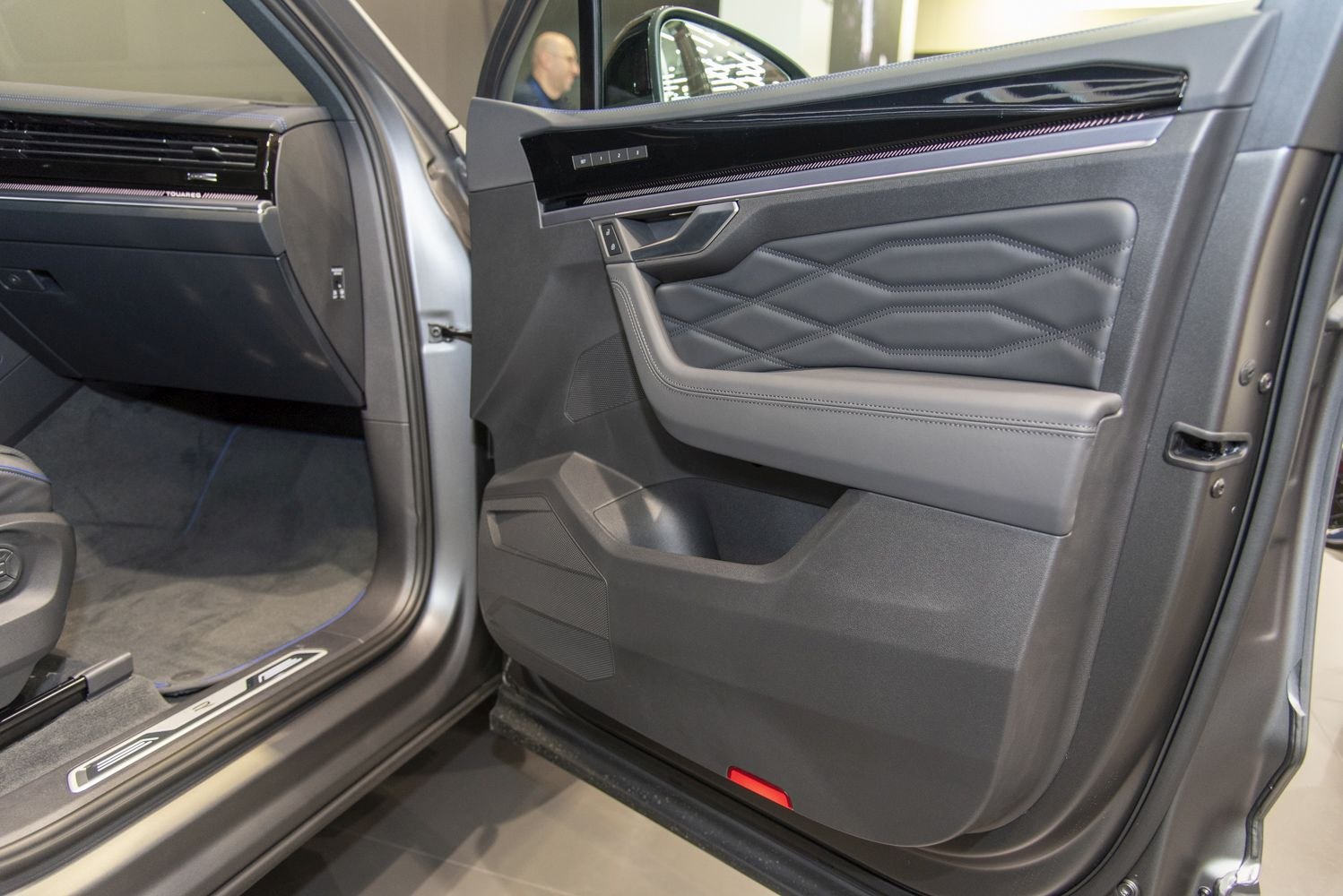 Interior door panel with stitched leather and control buttons