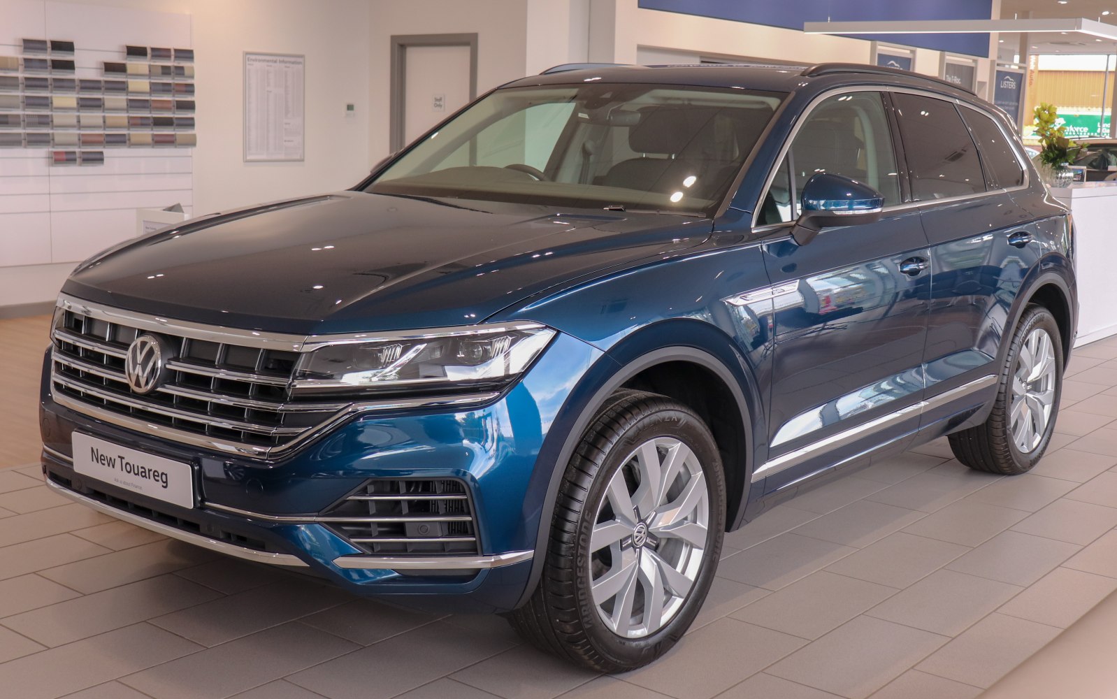 Blue SUV front side view with grille and alloy wheels