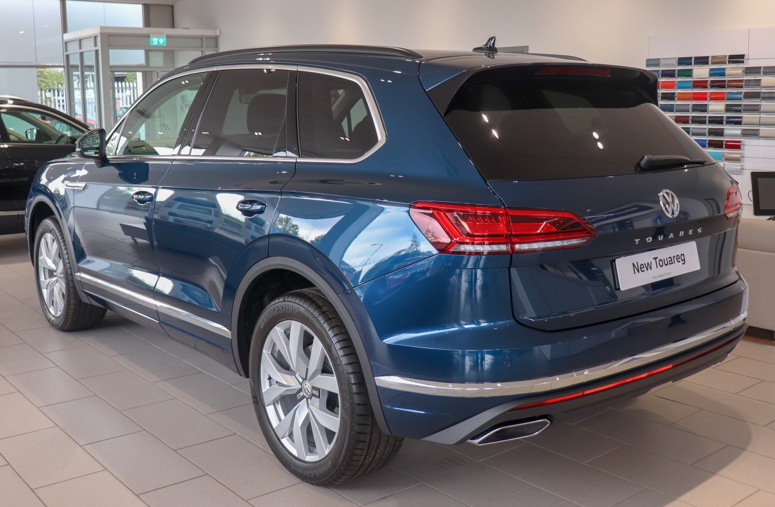 Rear side view of a sleek modern SUV with distinctive taillights and alloy wheels