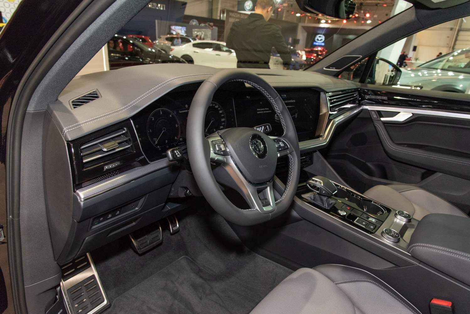 Luxury SUV interior with digital dashboard and advanced steering wheel