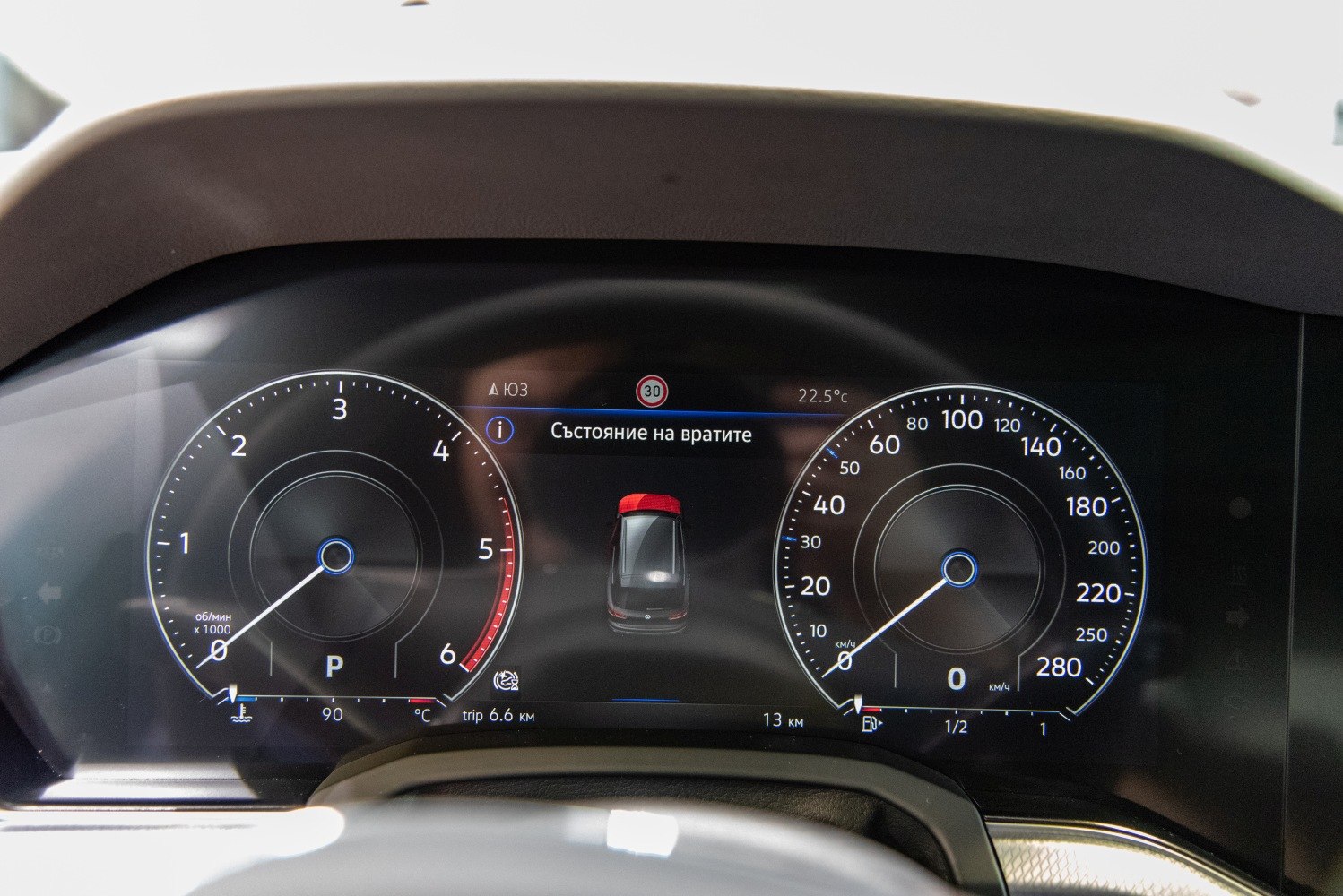 Digital instrument cluster with speedometer, tachometer, and door status indicator