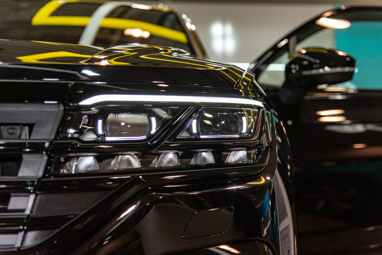 Close-up of modern LED headlight and front grille design