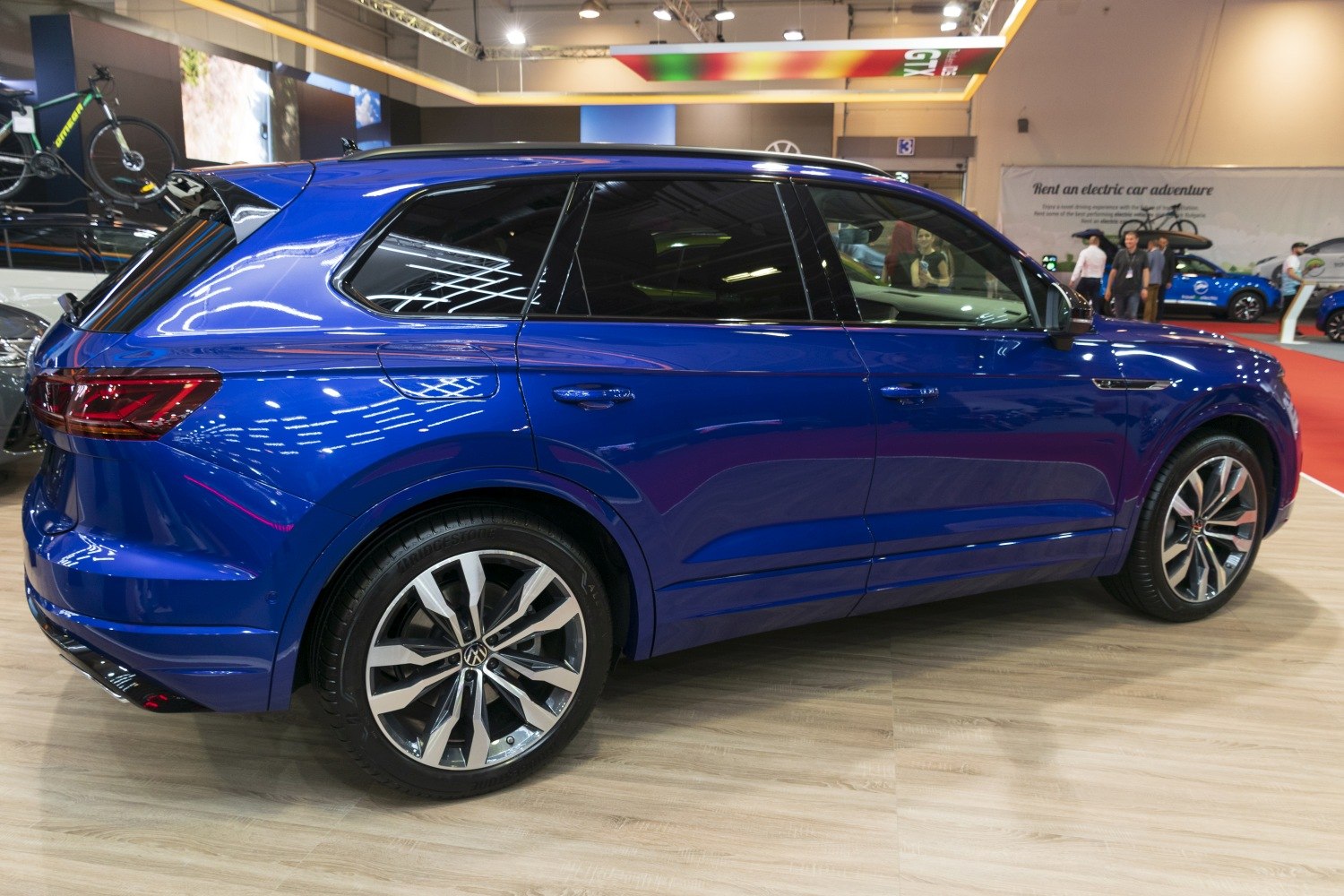Blue SUV side view with alloy wheels and tinted windows