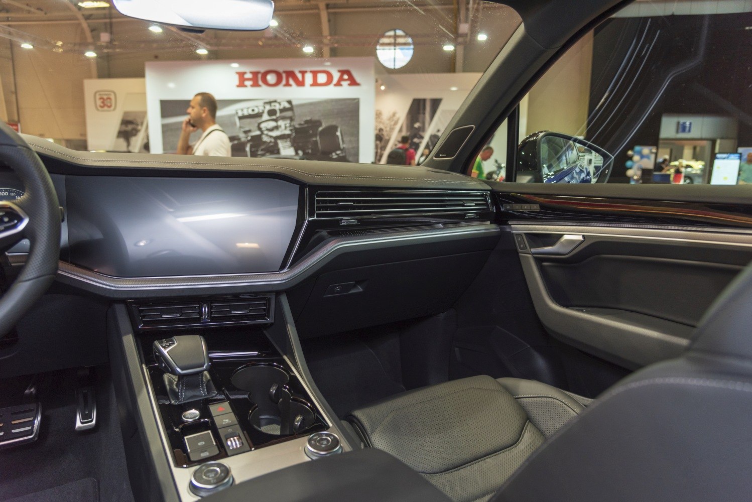 Modern car interior dashboard with digital displays and gear shift
