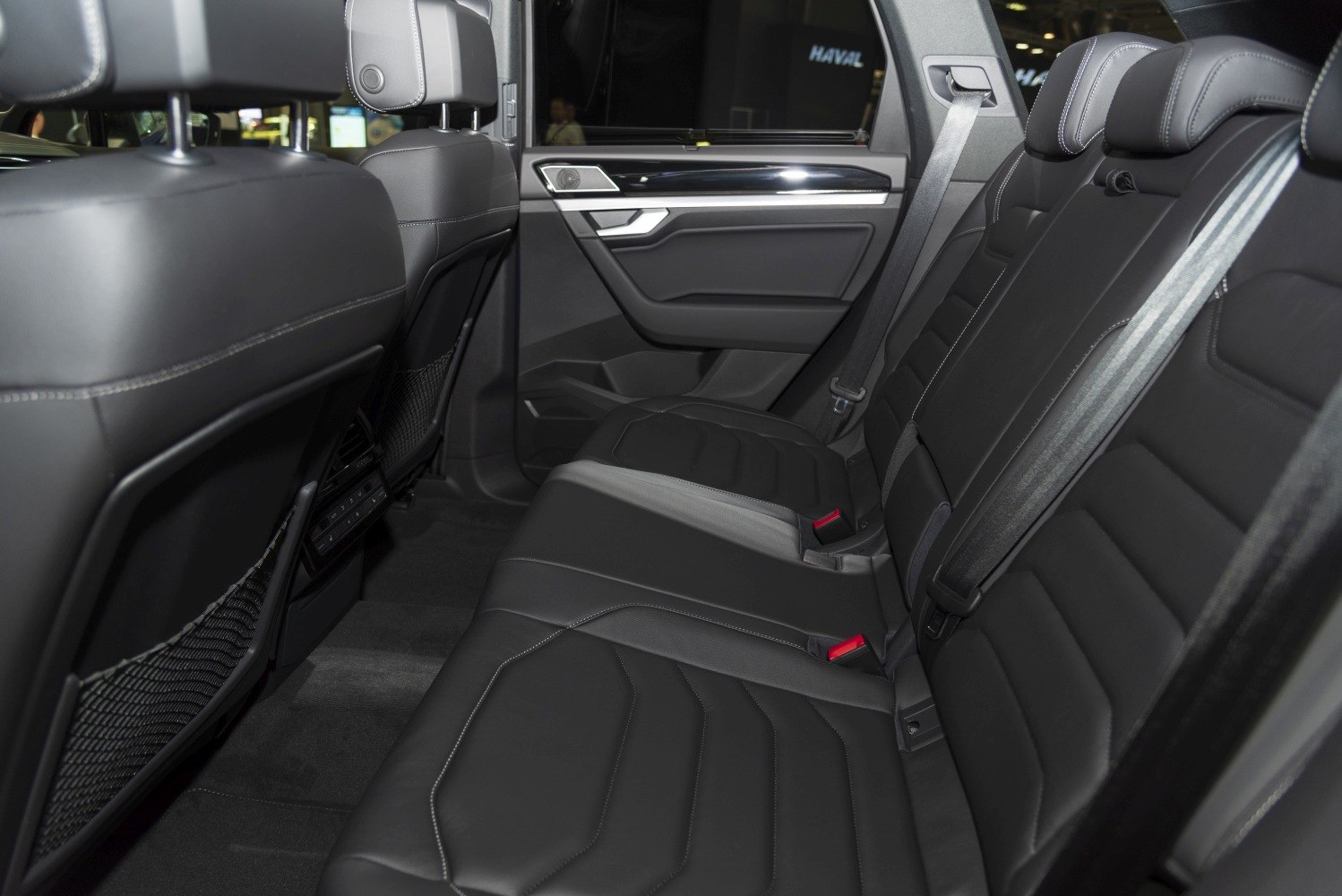 Black leather rear seats with detailed door panel and seat belts