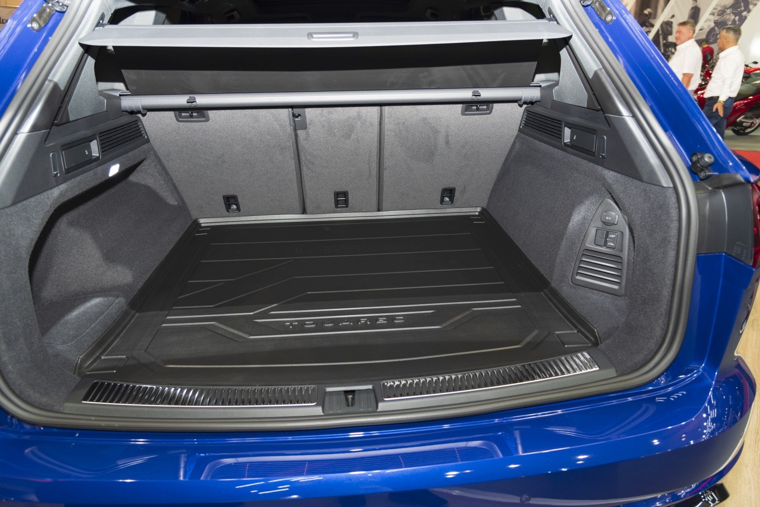 Spacious rear cargo area with protective mat and side compartments