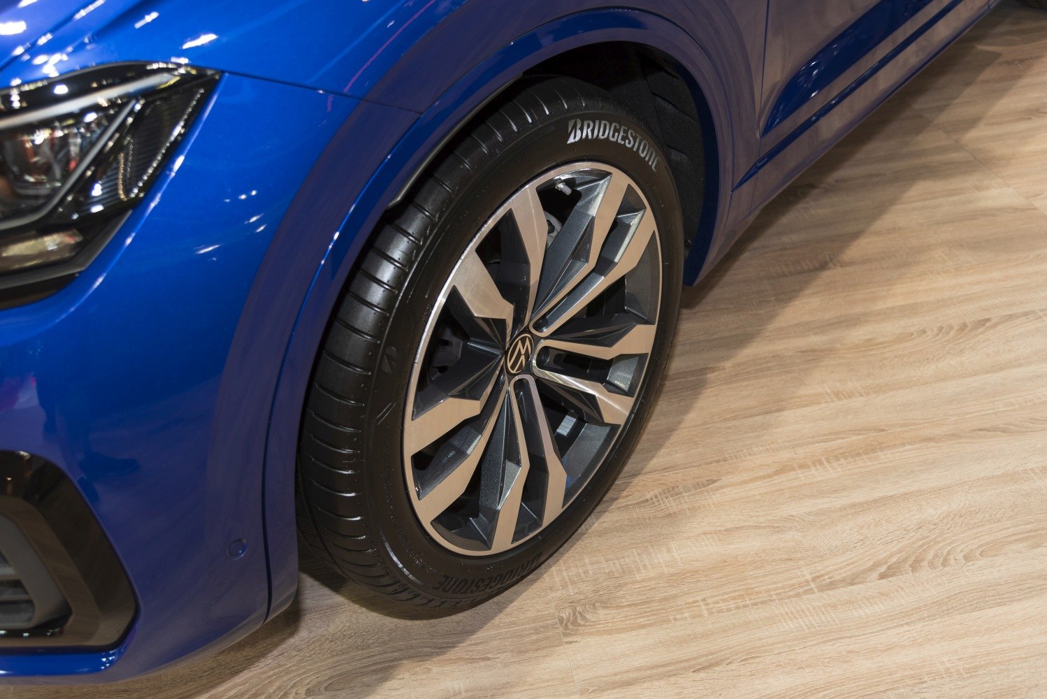 Close-up of alloy wheel and car headlight