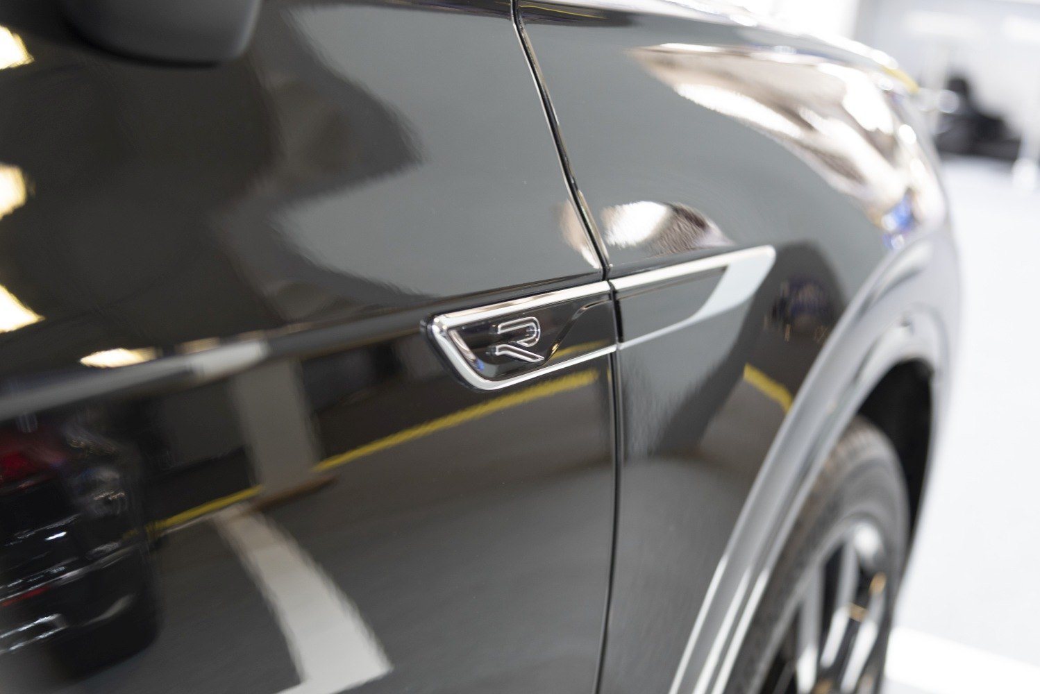 R-Line badge and side trim on black vehicle surface