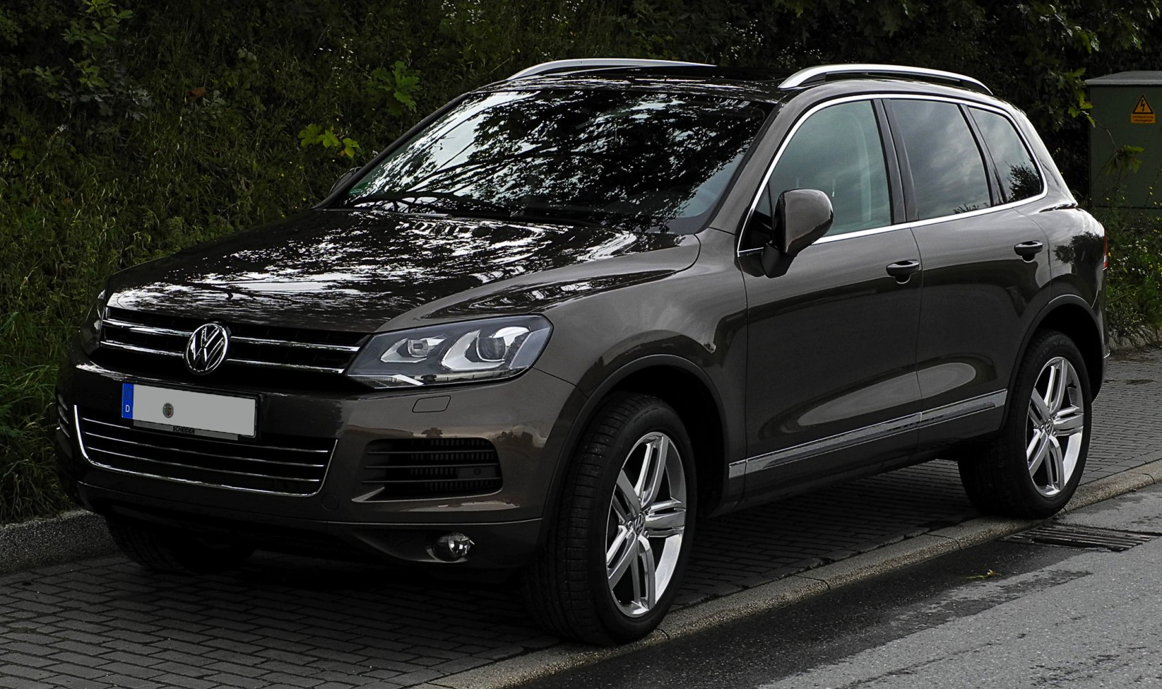 Front side view of SUV with modern headlights and alloy wheels
