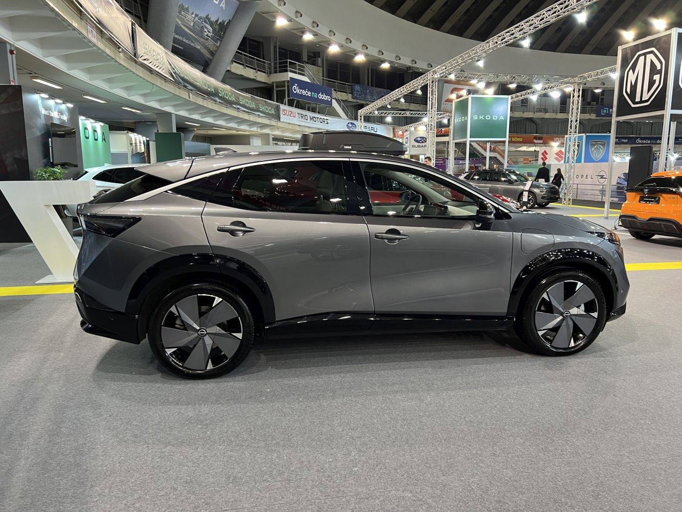 Side profile of electric SUV with aerodynamic shape and distinct wheel design