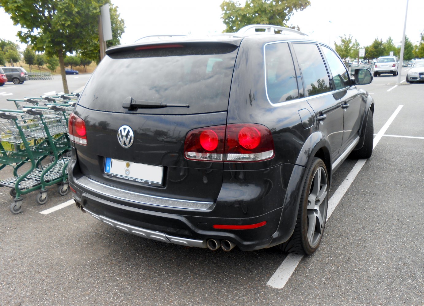 Rear view showing tail lights, dual exhaust, and rear windshield wiper