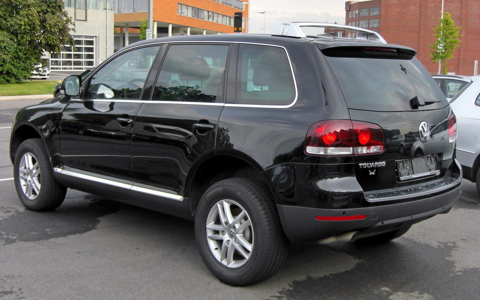 Rear and side view of black mid-size SUV with alloy wheels.