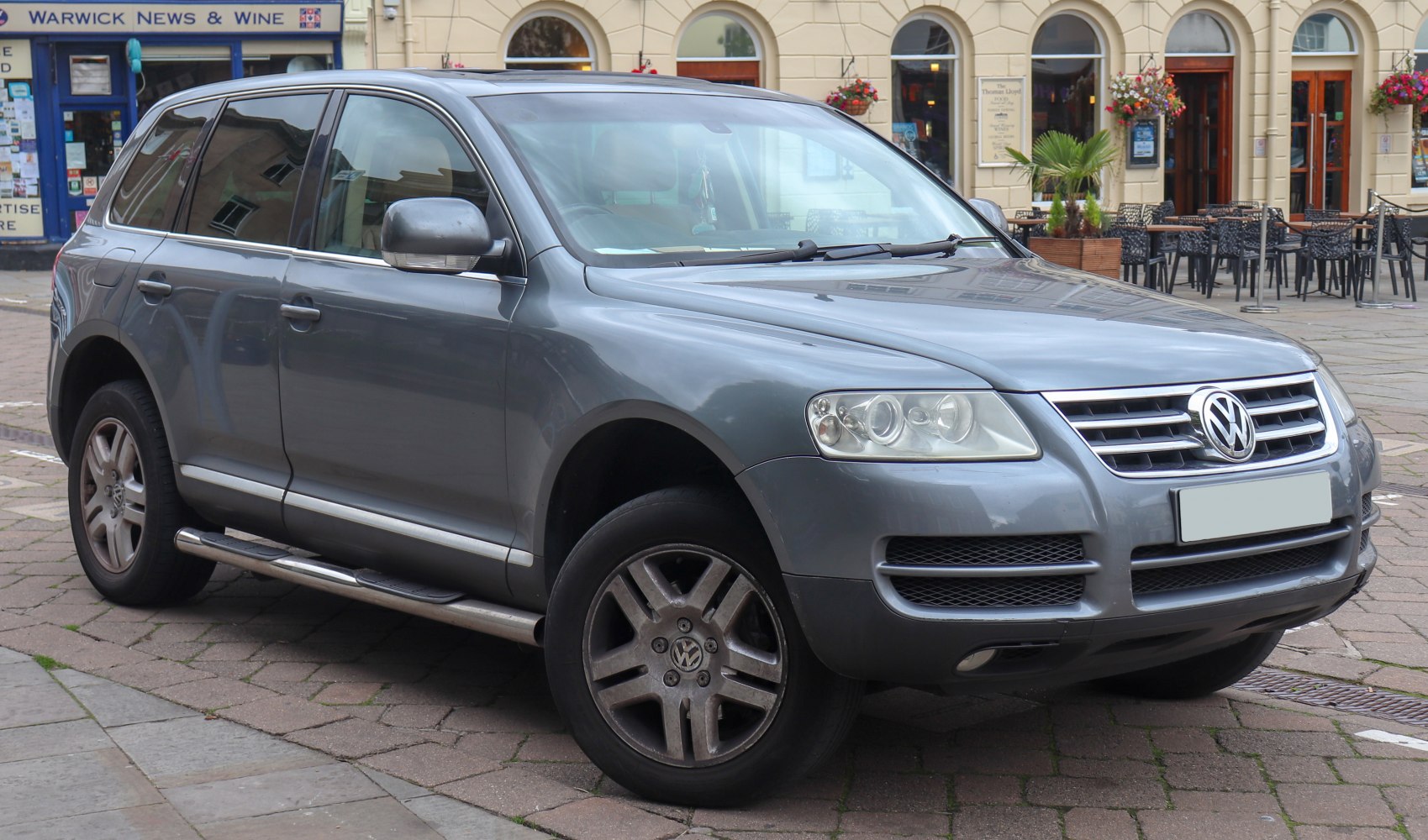 Front-side view of SUV with grille, headlights, and alloy wheels