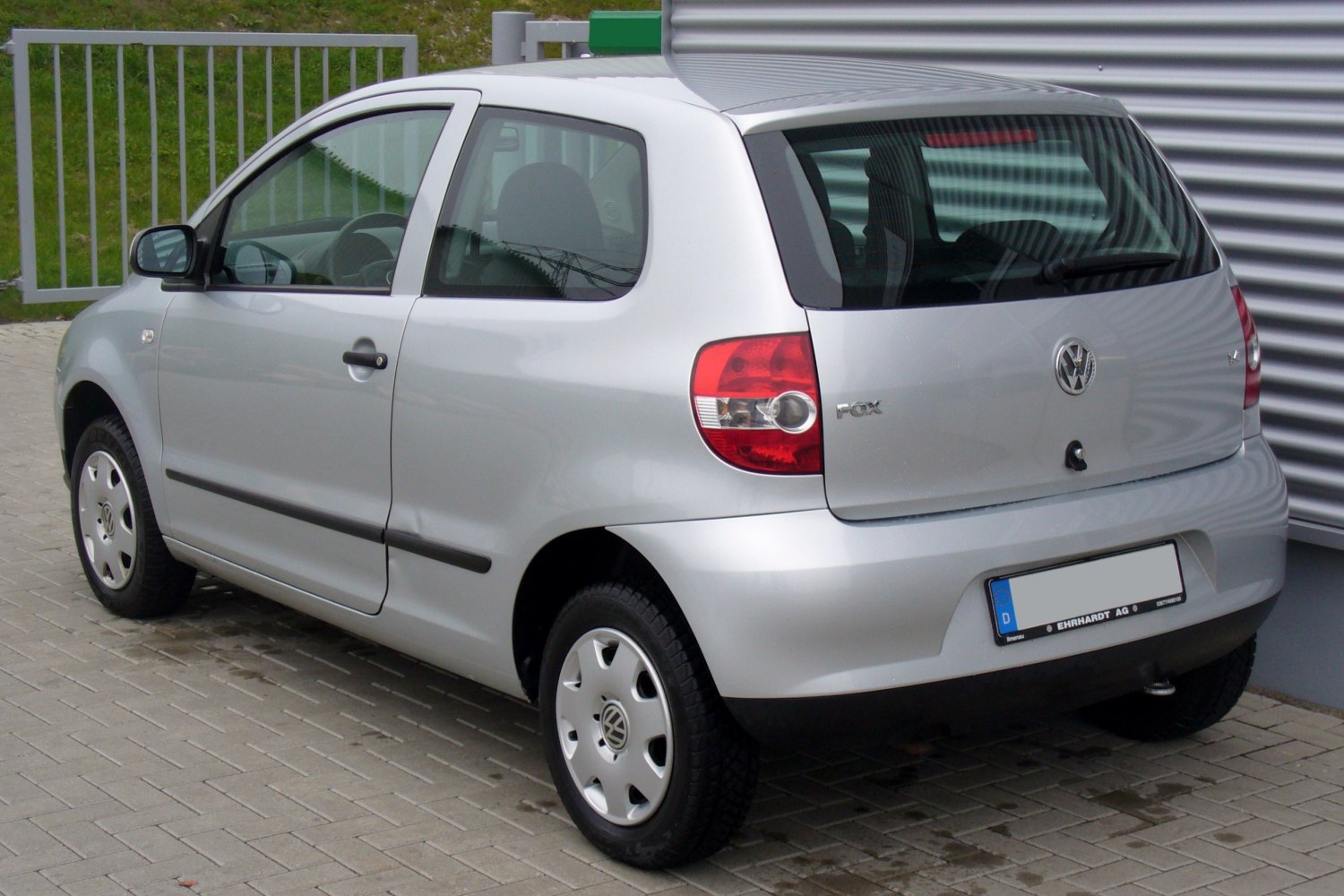 Silver 3-door hatchback rear side view with rounded taillights