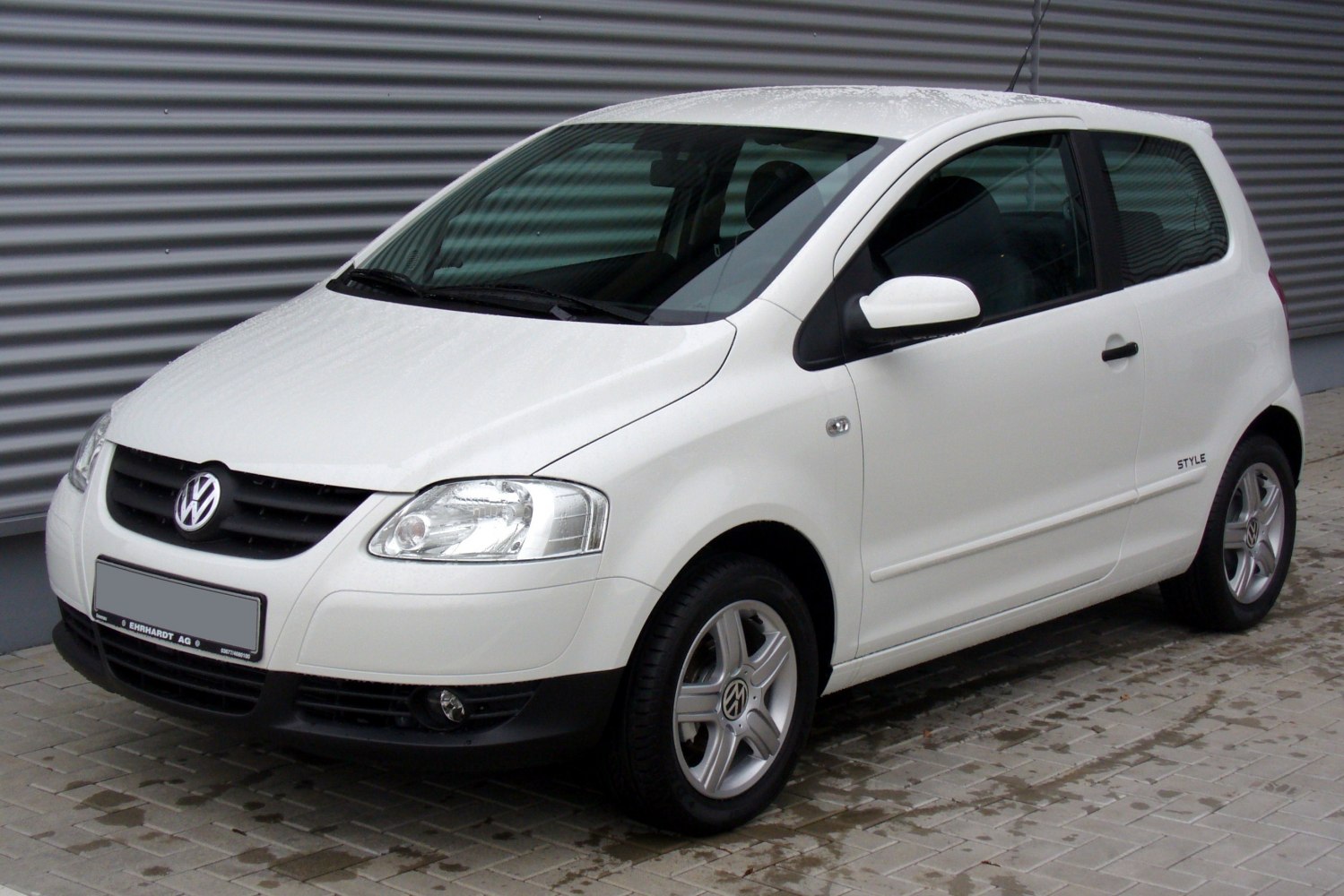 White compact hatchback three-door front side view