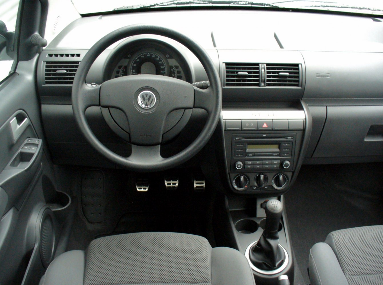 Dashboard with steering wheel, manual gear shift, and ventilation