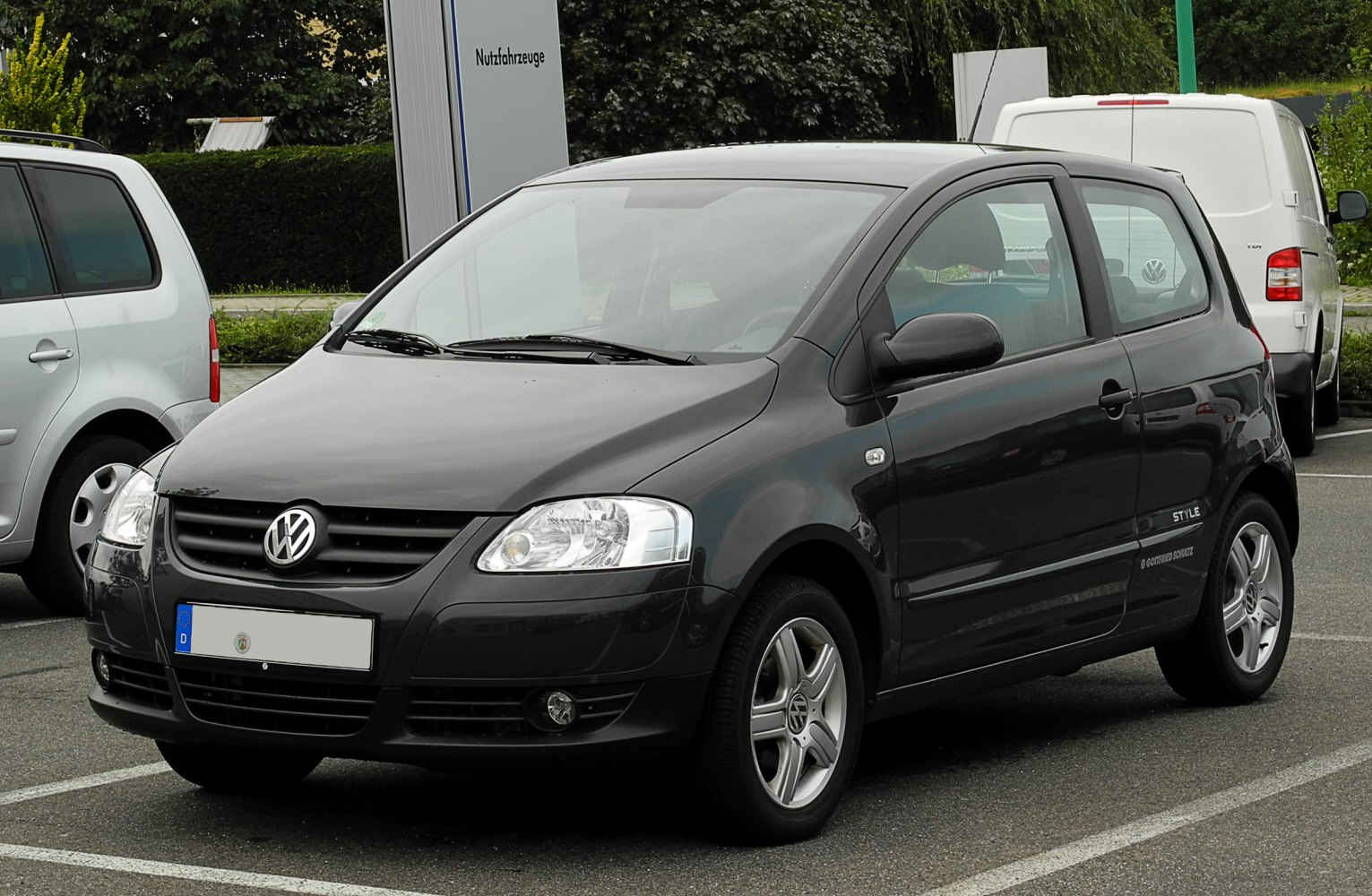 Compact black 3-door hatchback front-side view with alloy wheels