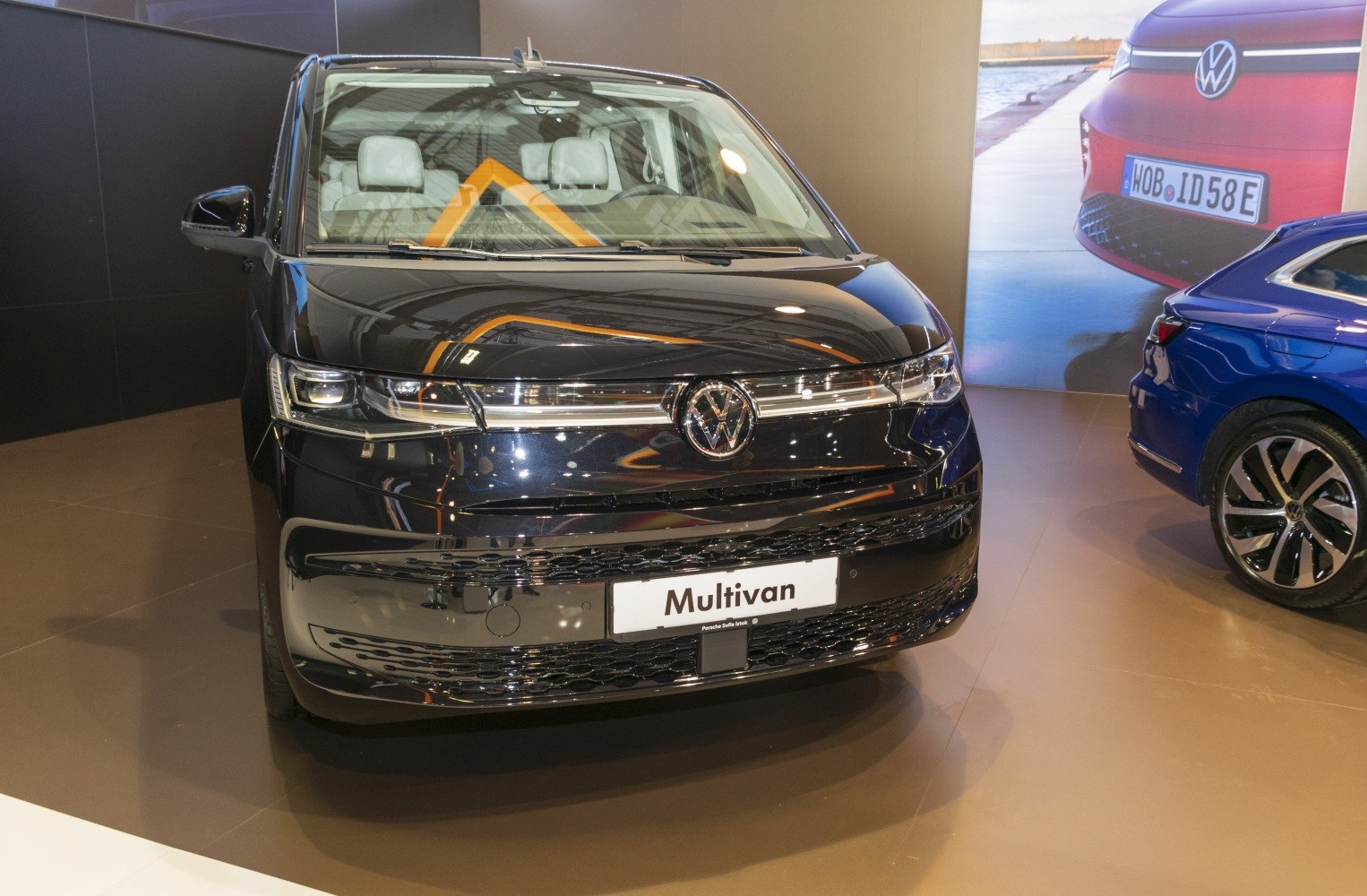 Front view of a modern MPV with sleek headlights and large windshield