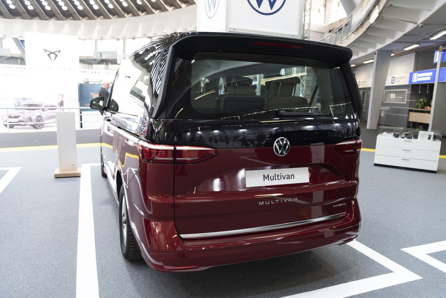 Rear design of a hybrid van with distinct taillights and large rear window