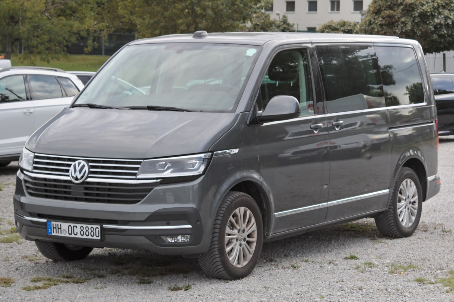Front and side view of a modern van with distinctive grille and sleek headlights.