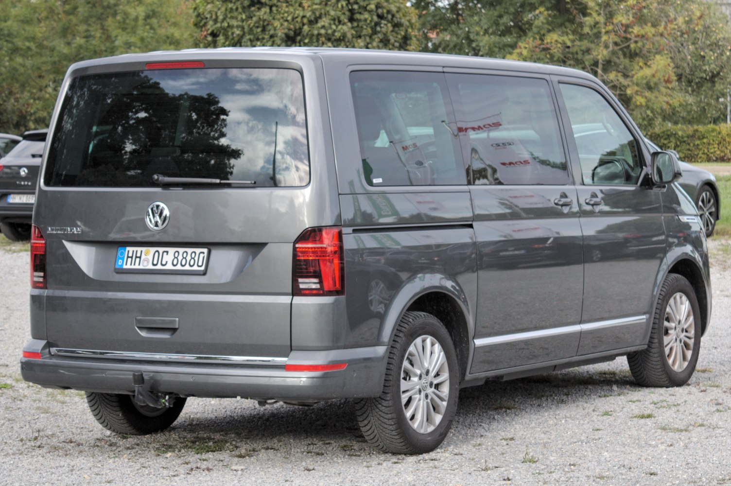 Rear view of a large van with distinctive tail lights and rear window