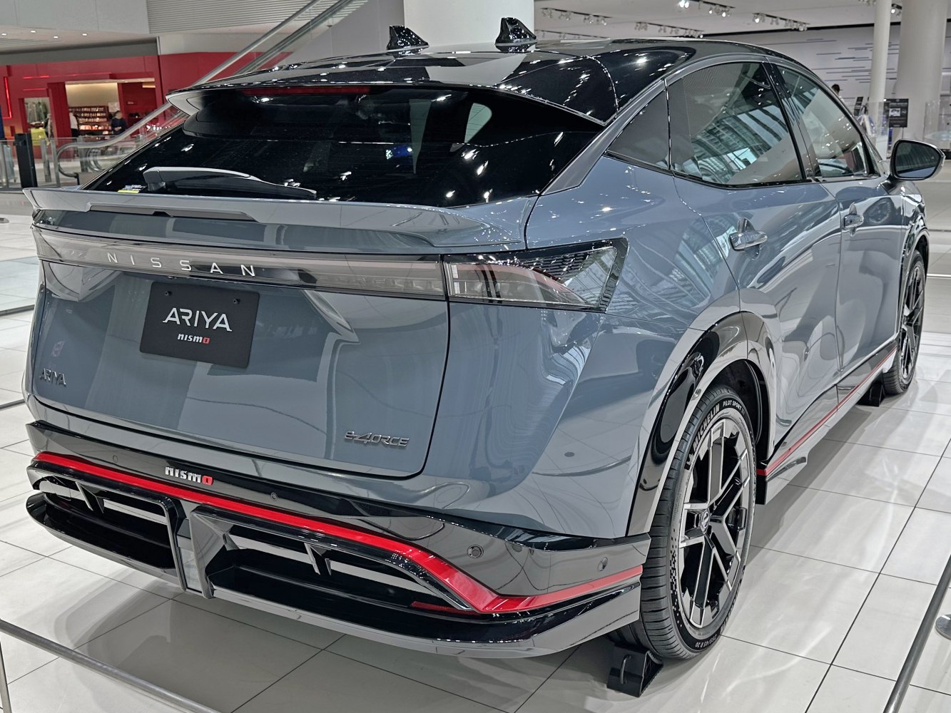 Rear three-quarter view showing sleek design and Nismo features