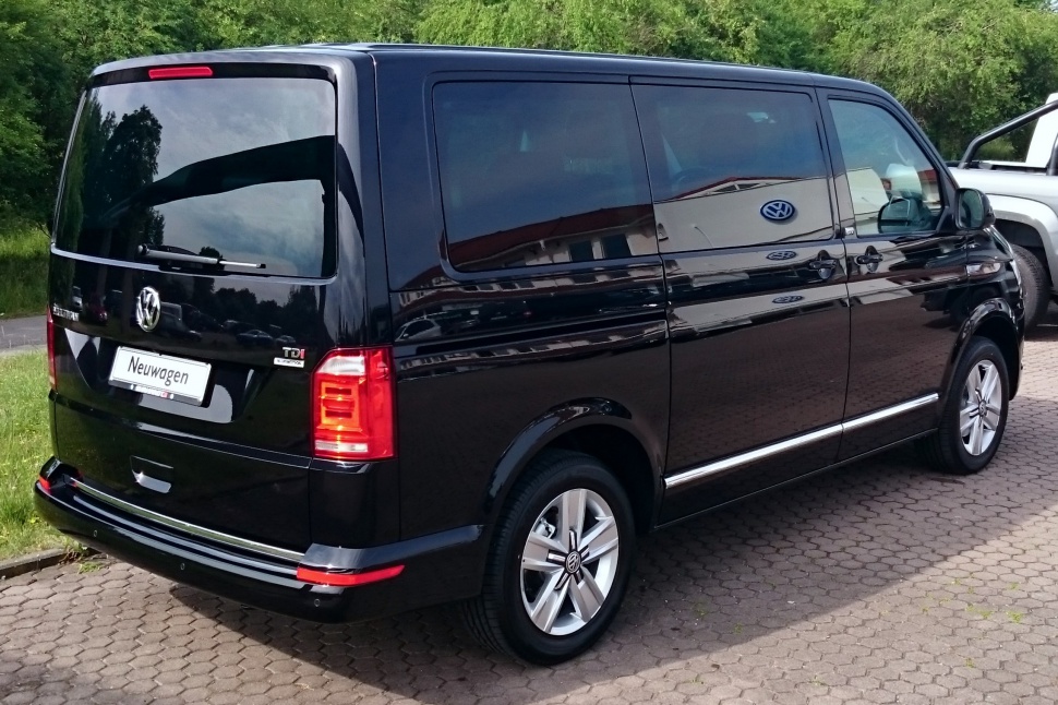Rear and side view of a black van with tinted windows and alloy wheels