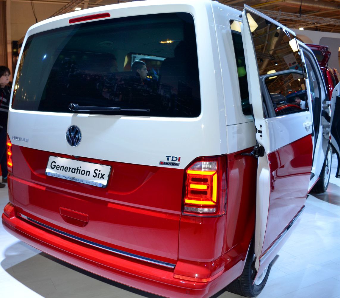 Rear view with illuminated taillights and open sliding door