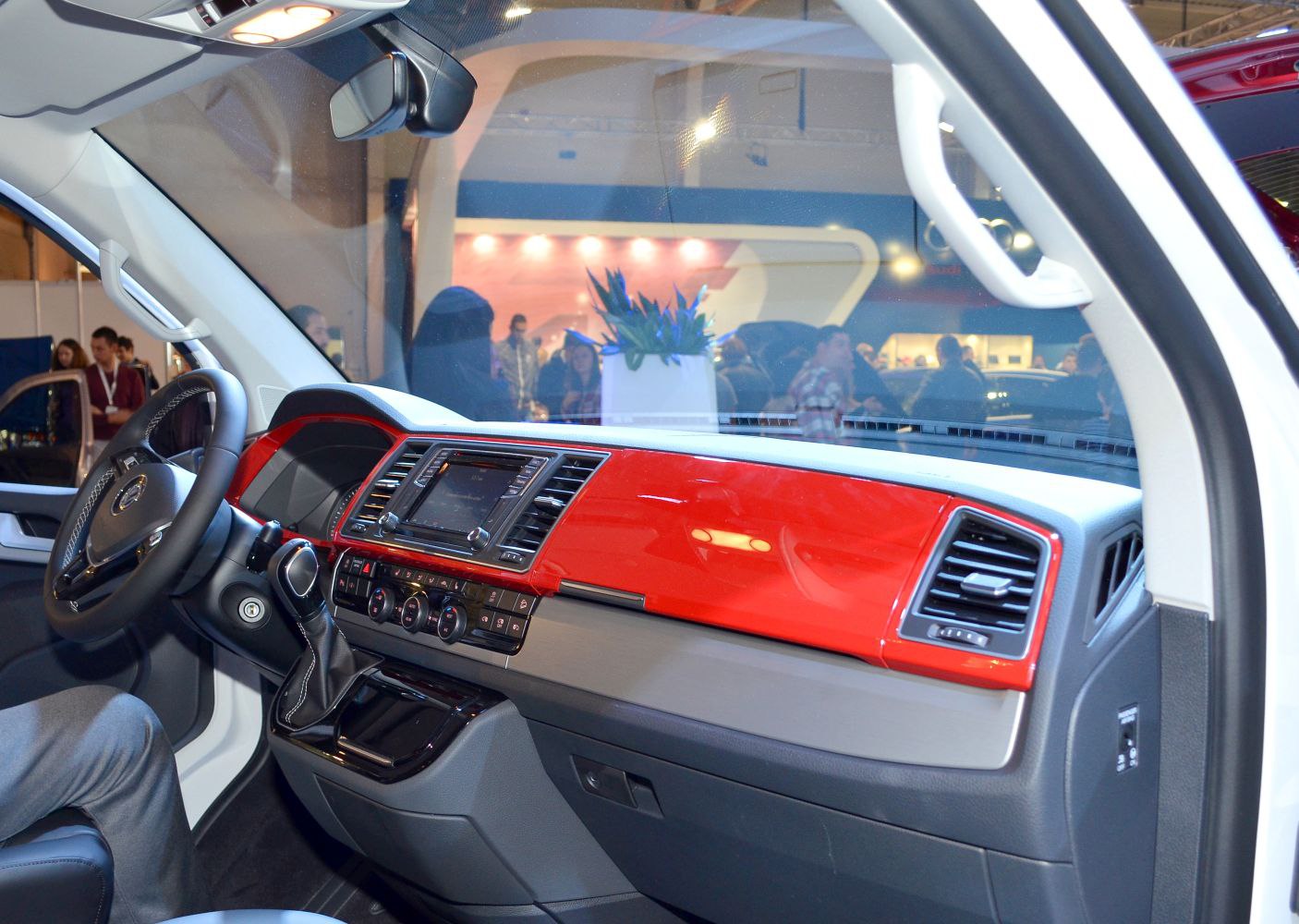 Red dashboard with infotainment system and steering wheel.