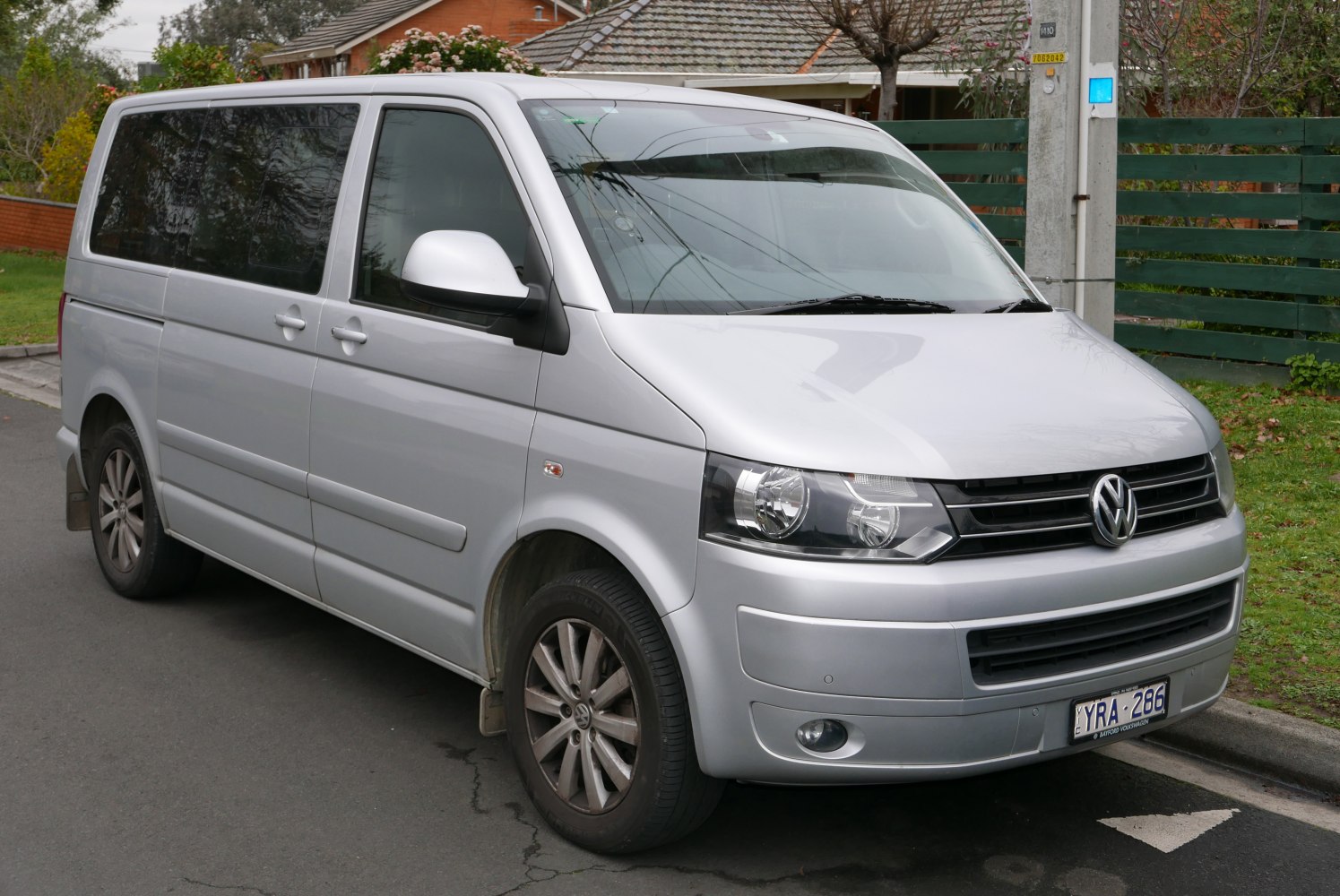 Silver mid-size van with modern headlights and tinted windows
