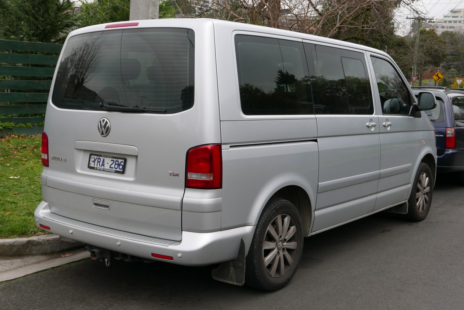 Silver large passenger van rear with sliding side door and alloy wheels