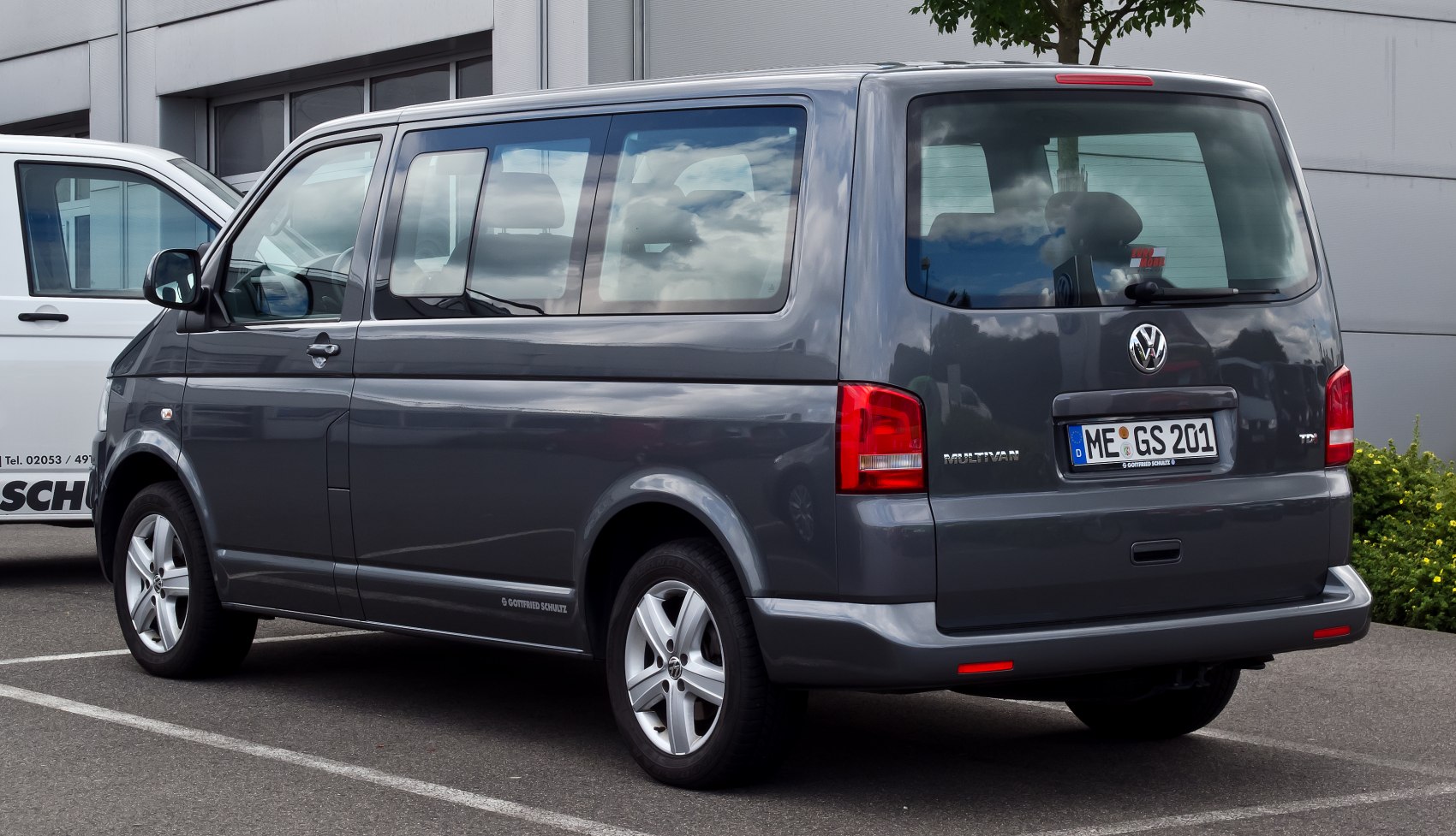 Side and rear view of a van with large windows and alloy wheels