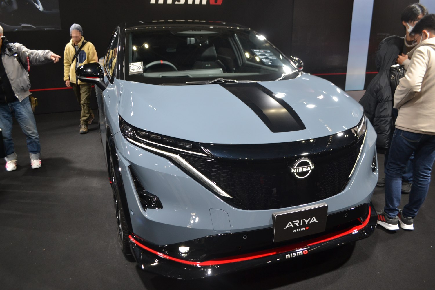 Front view of electric SUV with black hood stripe and sleek LED headlights