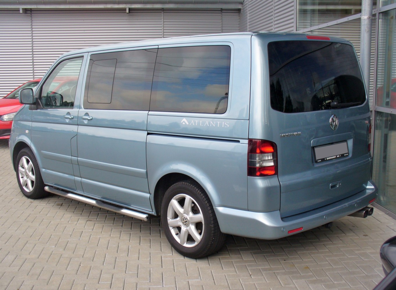 Rear and side view with tinted windows, alloy wheels, and chrome side steps