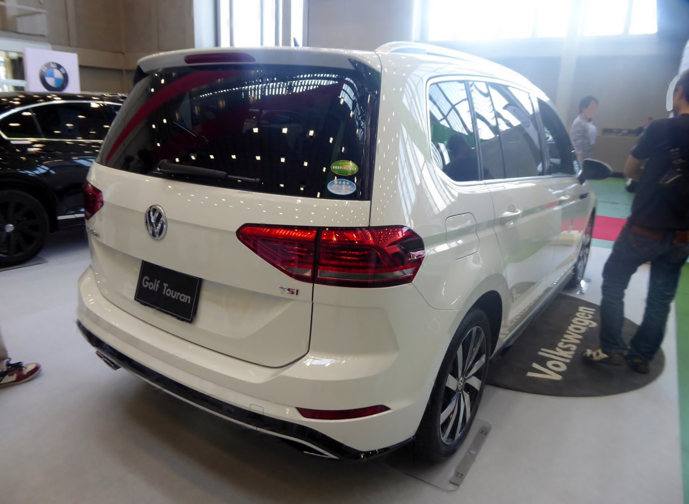 Rear view with distinctive tail lights and rear hatch of a minivan.