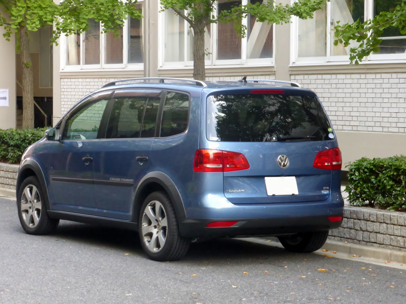 Rear and side view with tinted windows and roof rails